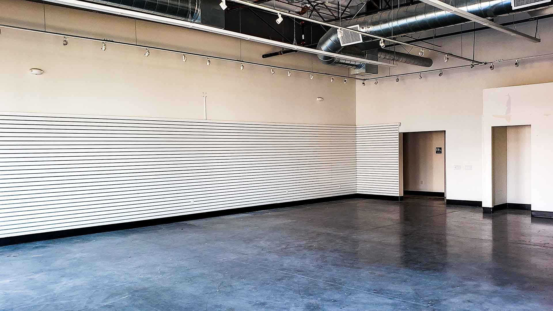 Cement Floors, Retail Wall Hangar Board, & Open Ceiling